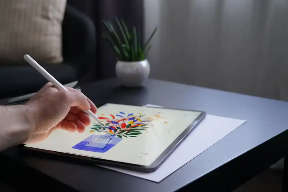Digital illustrator creating colourful artwork on a tablet